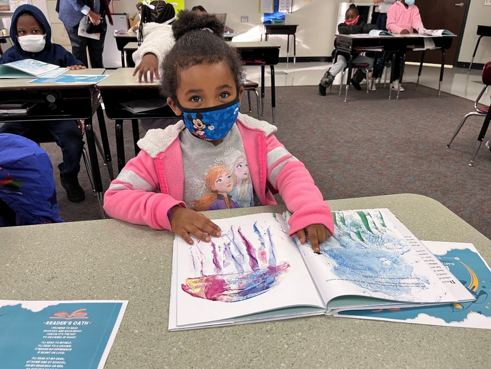 Student at Bond Elementary School reading Swimmy by Leo Lionni.